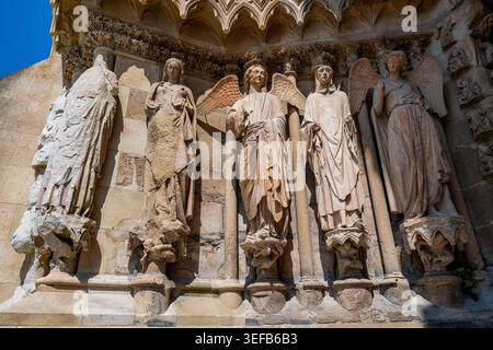 Artistic details of sculptures on the facade of Notre Dame cathedral in Reims, France showcasing historical figures and their craftsmanship Stock Photo