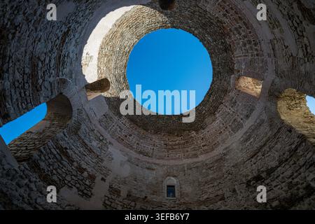 Exploration of ancient architecture in cellars showing circular structure and blue sky in Croatia Stock Photo