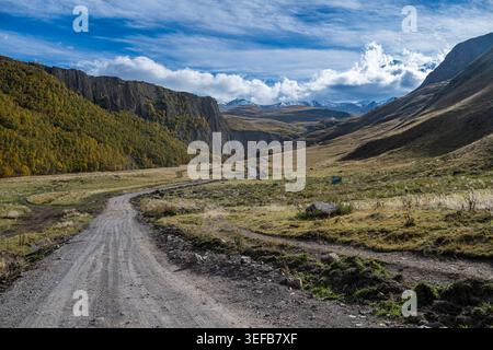 Scenic view of winding dirt road through mountains in Kabardino-Balkaria, Russia near Mount Elbrus Stock Photo