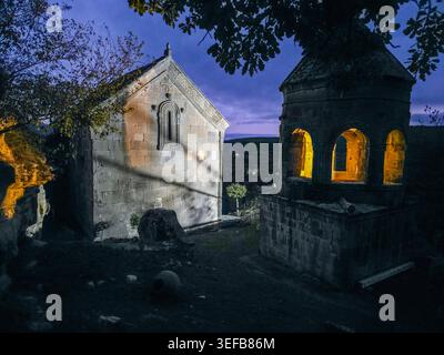 Night view of Tiri monastery with lit windows in South Ossetia under dark sky Stock Photo