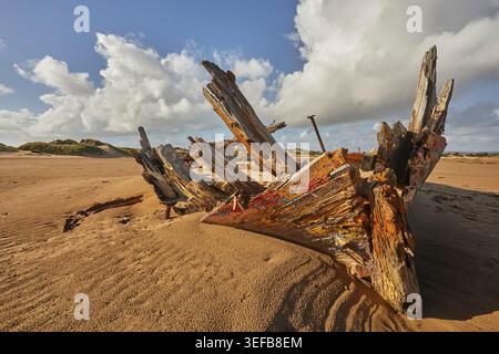 Disintegrating wreck rests on sand at Crow Point near Barnstaple in Devon, Great Britain Stock Photo