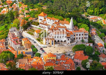 View of Sintra National Palace surrounded by trees and houses in Sintra, Portugal from above Stock Photo
