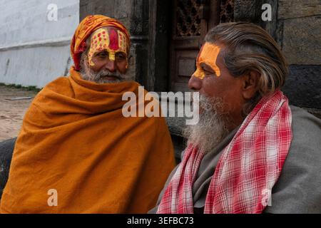 Portrait of two Hindu Sadhus in traditional attire at a public place in Kathmandu, Nepal during daytime Stock Photo