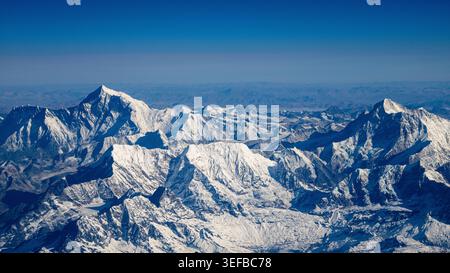 Himalaya mountain range seen from the air in Nepal showcasing snow and rock formations at high altitude Stock Photo