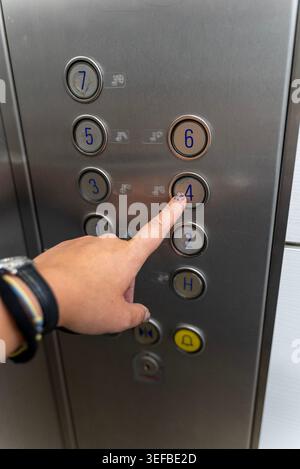 Person pressing elevator button inside modern lift cabin Stock Photo