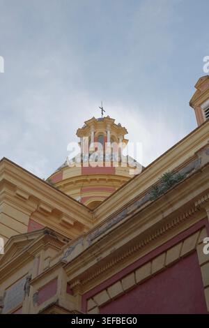Low angle view of the ornate tiled dome and lantern cupola with weather vane cross of San Ildefonso Church, Seville, Andalusia, Spain. Stock Photo