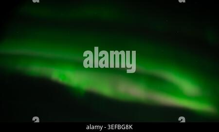 Sweeping ribbons of green aurora borealis swirling across the night sky, Tromsø region, Arctic Norway, Scandinavia, winter night photography. Stock Photo
