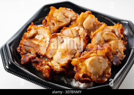 Japanese Chicken Rice Bowl (Torimeshi) Bento in Takeaway Container with Sweet Soy Sauce Stock Photo