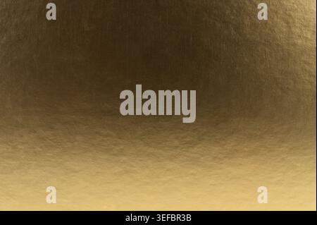 Golden metal gradient texture background with small scratches close up view Stock Photo