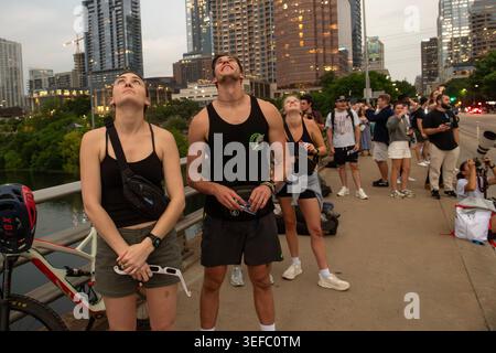 Viewers watch a total eclipse from Ann W. Richards Congress Avenue Bridge, Austin, Texas, April 8, 2024. (Photo by John Anderson) Stock Photo