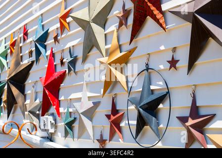 Colorful painted stars on exterior wall in the afternoon light. Stock Photo