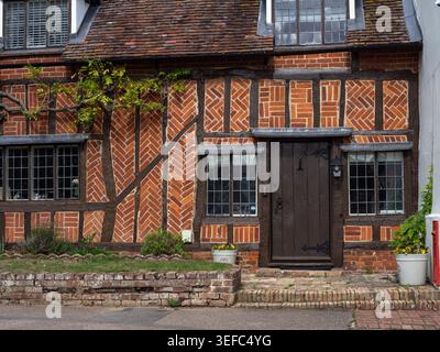 Half timbered and brick historic building in the village of Cavendish, Suffolk, UK Stock Photo
