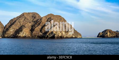 Coast of Oman illuminated by setting sun Stock Photo