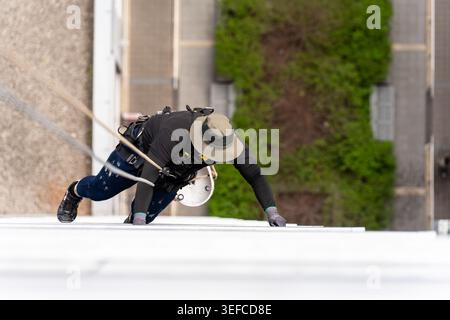 High angle view of window cleaners on modern skyscraper facade Stock Photo