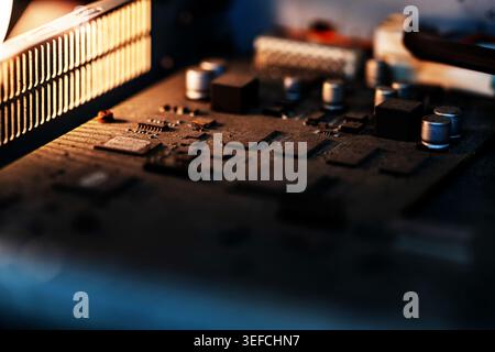 This close-up image showcases a detailed view of a computer motherboard with various electronic components, microchips, and circuitry, highlighting te Stock Photo