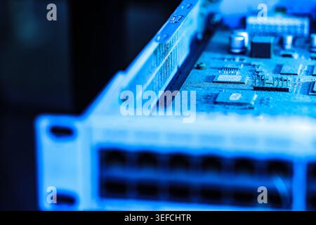 This detailed image showcases a computer motherboard with various electronic components, microchips, and circuit pathways, emphasizing modern digital Stock Photo