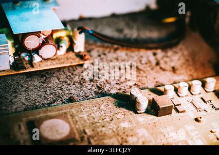 This close-up image showcases a detailed view of a circuit board with electronic components, including capacitors and resistors, used in electronic de Stock Photo