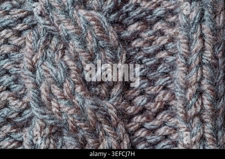 Macro view of a textured knitted textile showcasing the intricate weave and fuzzy fibers of wool or acrylic yarn Stock Photo