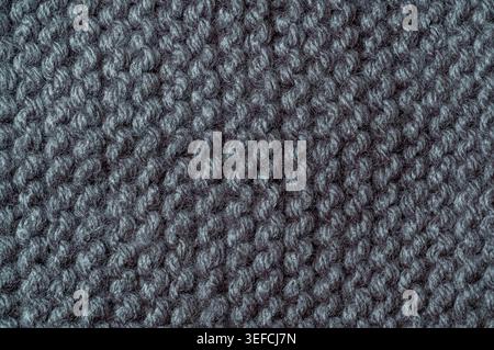 Detailed macro view of a woven textile, showcasing the intricate pattern and fuzzy texture of the wool or acrylic fibers Stock Photo