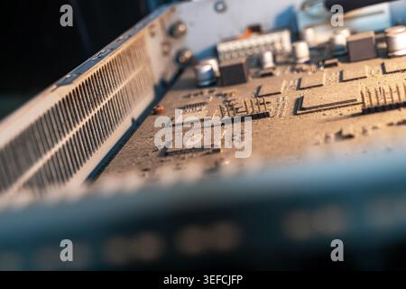 A detailed close-up image of a computer graphics card showcasing intricate electronic components, microchips, circuit pathways, and hardware elements. Stock Photo