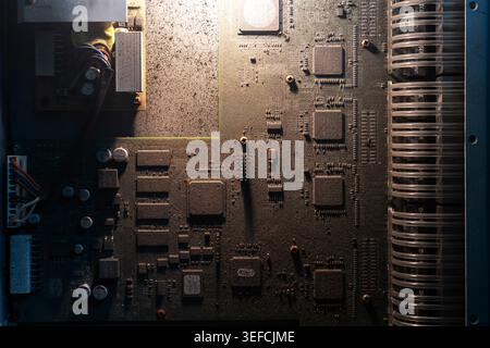 This detailed close-up image shows a complex electronic circuit board with numerous components, wiring, and microchips, highlighting advanced hardware Stock Photo