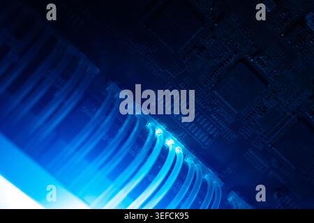 This image showcases a close-up view of data cables connected to a circuit board, highlighting modern electronic infrastructure and digital communicat Stock Photo