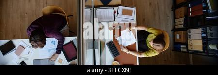 Header of Adult Employees Working at Separate Office Desks in Corporate Office Stock Photo