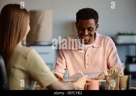 Black Man Reviewing Documents during Business Meeting Stock Photo