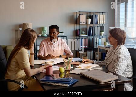 Diverse Business Team Discussing Strategy in Office Meeting Stock Photo