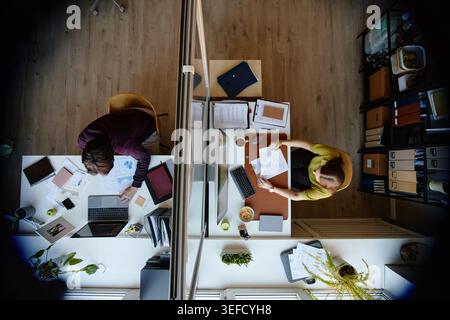 Businesswomen Working at Separate Desks in Modern Office Stock Photo