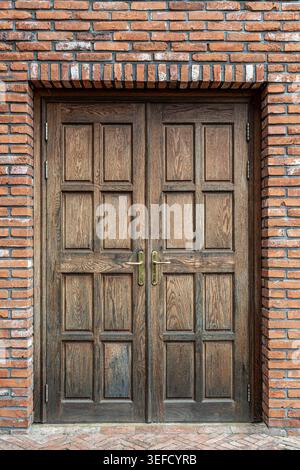 Close-up of Wooden Double Door and Red Brick Wall Stock Photo