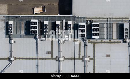 Aerial view of industrial HVAC units, ventilation fans, and complex piping systems on a flat rooftop, Utrecht, Utrecht, Netherlands. Stock Photo
