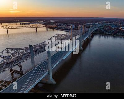 Aerial view of the Abraham Lincoln Bridge and John F. Kennedy Memorial Bridge spanning the Ohio River at sunset with the city skyline in the backgroun Stock Photo