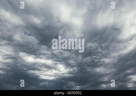 Gloomy weather view. Dramatic dark gray clouds in the sky. Stock Photo