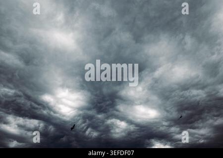 Dramatic dark gray sky background. Heavy storm clouds gathering in the atmosphere. Stock Photo