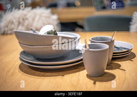 A stylish gray ceramic dinnerware set on the counter Stock Photo