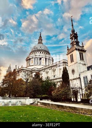 St Paul's Cathedral In London With Historic Dome Towers Against Dramatic Sky Over City Gardens Stock Photo