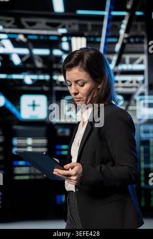 Equipment optimizing, tablet and software developer in server farm, augmented reality upgrade. Employee, data center and VFX compositing futuristic technology, updating system electronics with device Stock Photo
