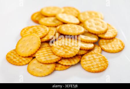 Heap of crispy salted crackers on white background Stock Photo