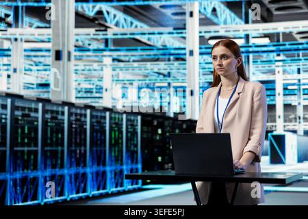 Network threats, laptop and programmer in data center deploying protection. Auditing systems, notebook and cybersecurity department worker in server farm fixing computer bugs Stock Photo