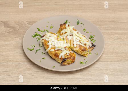slate plate holds several freshly prepared Vietnamese spring rolls, their ends revealing a strip of roasted pork and shrimp skin, accompanied by a spr Stock Photo