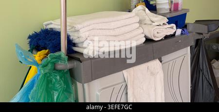 hotel cleaning cart with fresh towels and various supplies, ready for service Stock Photo