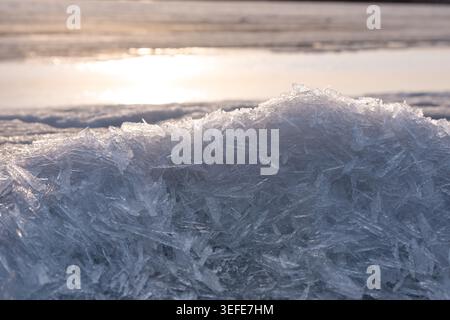 Sharp transparent ice crystal formations creating intricate geometric patterns in a detailed close‑up view Stock Photo