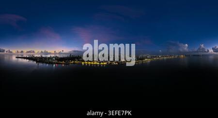 Aerial view of the illuminated Marine Drive promenade and the coastal skyline under a twilight sky in Mumbai, Maharashtra, India. Stock Photo