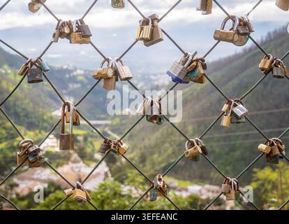 Love locks hanging on wire fence symbolizing eternal commitment Stock Photo