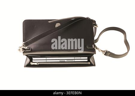 Close-up view of black Calvin Klein crossbody handbag with mobile phone inside isolated on white background. Sweden. Stock Photo