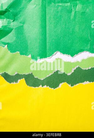 Torn paper strips in varying shades of green and yellow creating a layered abstract background texture with rough edges, modern mockup Stock Photo