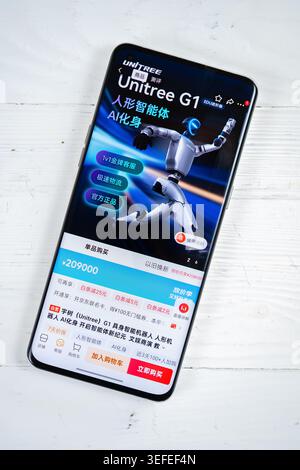 ZHONGSHAN China-May 4 2026: hand holding a smartphone displaying the Unitree G1 humanoid robot product page on JD.com at vertical composition. Stock Photo