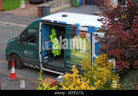 United Utilities worker and van maintaining sewers on a residential street in Grappenhall, Warrington, Cheshire. Stock Photo
