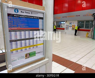 Warrington Interchange late at night, showing bus times for Stand 10 and an almost empty public transport concourse. Stock Photo